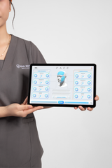 A lady holding a tablet displaying a facial analysis result of WonderFace Device. It is an ideal value for a LED device purchase.