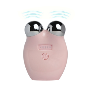 Pink electronic device with a round shape and two spherical massager components on a white background. It is a great EMS device purchase.