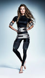 A lady wearing a full-body suit with a medical device 'Wonder' around his abs, both arms and stomach. It is a great value EMF and RF laser purchase.