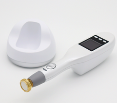 A handheld non-invasive plasma treatment device with a gold tip component lying on a surface. It is a great plasma device purchase.