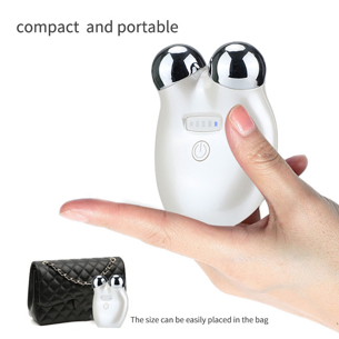 Small white device with device controls held in a hand, next to a black handbag showing its portable and easily fits in a purse. It is a great EMS device purchase.