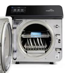 Midmark M9 Automatic Steam Sterilizer with the door open, displaying the internal rack for instruments, featuring a digital display and control panel on top.