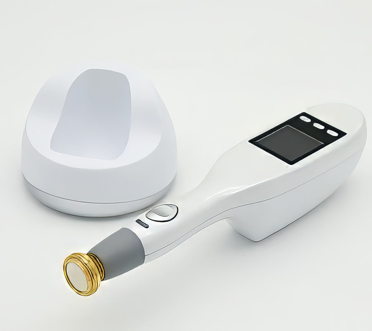 A handheld non-invasive plasma treatment device with a gold tip component lying on a surface. It is a great plasma device purchase.