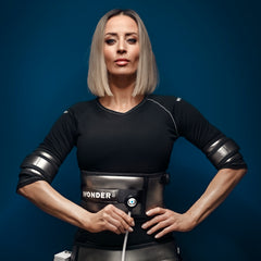 Woman wearing a black outfit with a 'Wonder' medical device. It is a great value EMF and RF laser purchase.